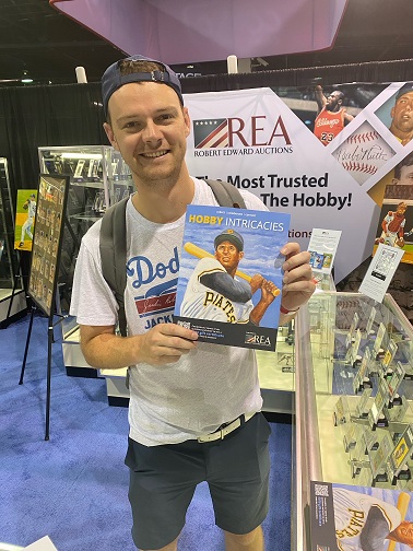 Gordy visiting the REA booth during the 2023 National in Chicago, holding a copy of the company's new magazine "Hobby Intricacies"